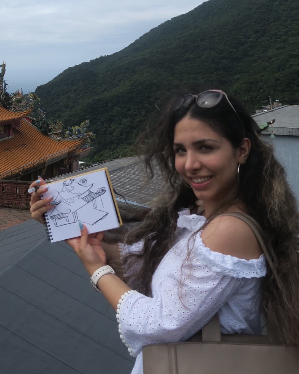 Nika Sahih, founder and tutor at Ace Academy, sketching a temple while travelling